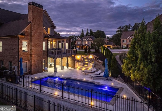 109 Slate Dr, Buford, GA 30518 - pool at dusk with a fenced backyard, a hot tub, and a patio area