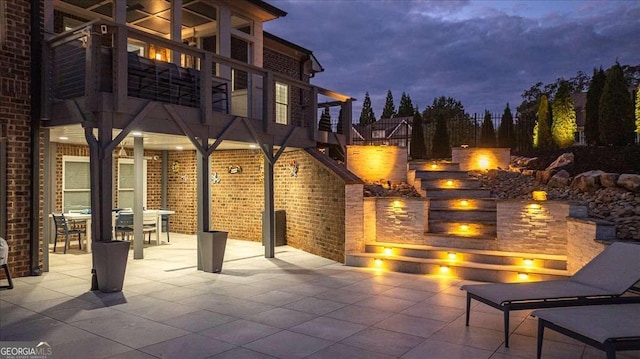 109 Slate Dr, Buford, GA 30518 - patio at night with a patio, an outdoor fire pit, outdoor dining space, and a balcony