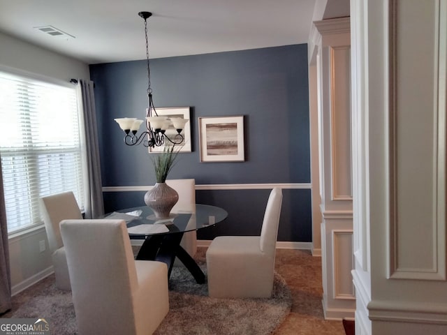 dining space with a notable chandelier