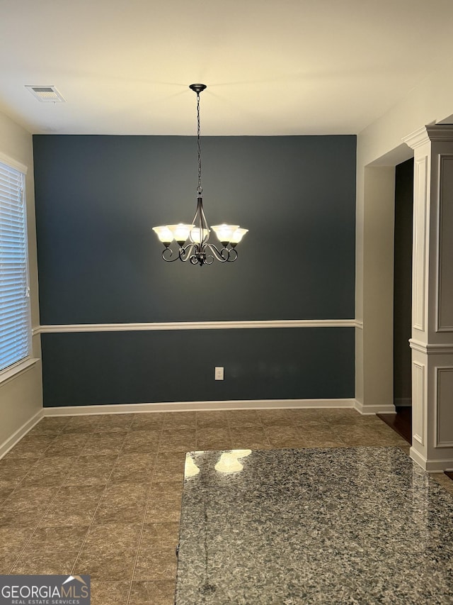 empty room with a notable chandelier