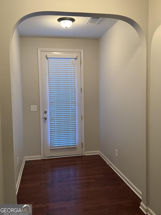 doorway with dark hardwood / wood-style floors