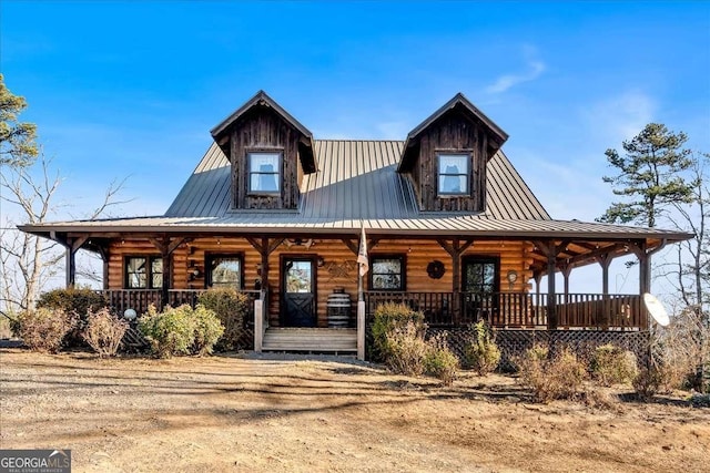 log-style house with covered porch