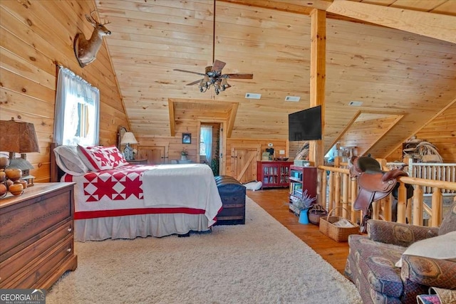 bedroom featuring ceiling fan, wood-type flooring, vaulted ceiling, and wood walls