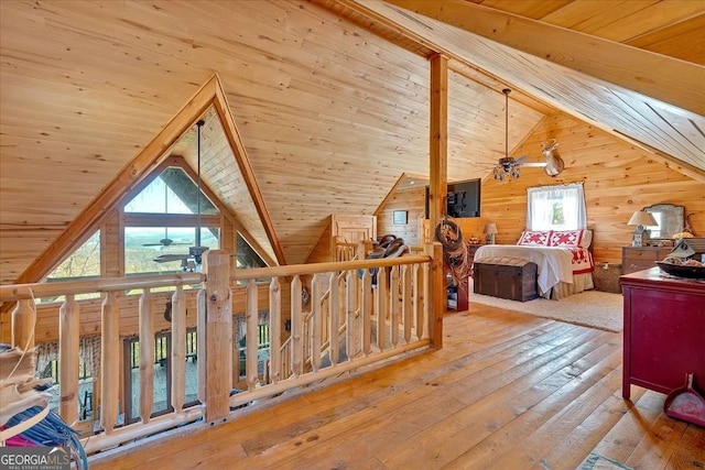 bedroom featuring light hardwood / wood-style floors, lofted ceiling with beams, multiple windows, and wooden ceiling