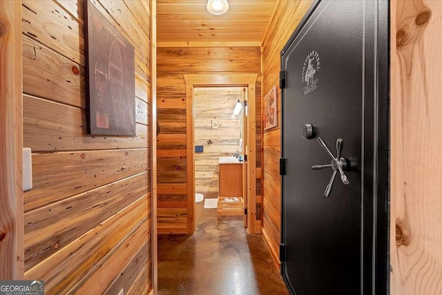 hall with wooden ceiling and wood walls