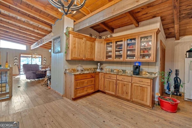 kitchen featuring vaulted ceiling with beams, a notable chandelier, light hardwood / wood-style floors, light stone countertops, and wooden ceiling