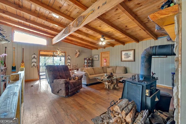 living room featuring wood ceiling, lofted ceiling with beams, light wood-type flooring, a wood stove, and ceiling fan