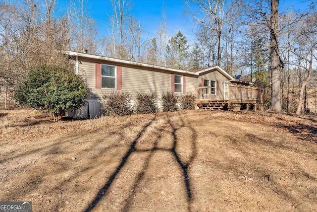 manufactured / mobile home with a wooden deck