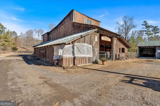 view of property exterior with an outbuilding