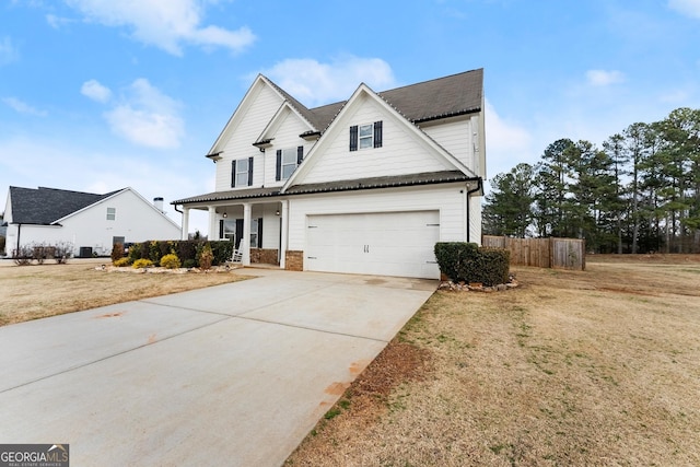 view of front facade featuring a porch, a garage, and a front lawn