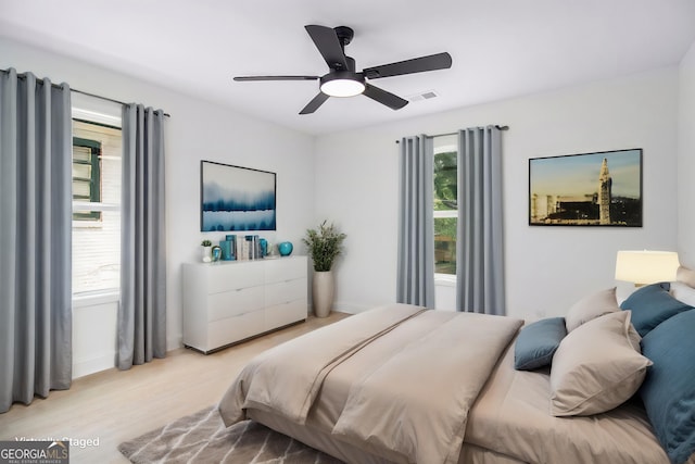 bedroom featuring ceiling fan and light hardwood / wood-style flooring