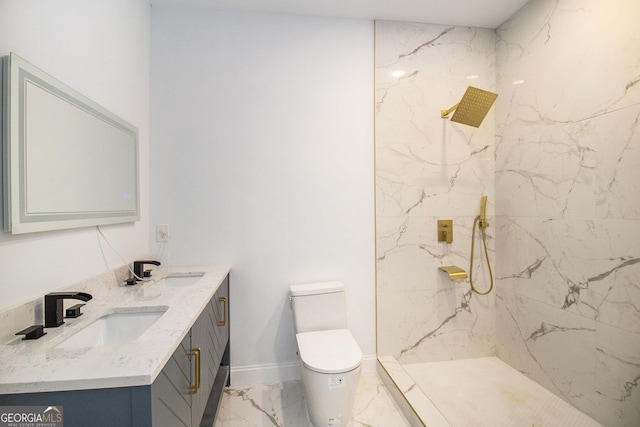 bathroom featuring tiled shower, vanity, and toilet