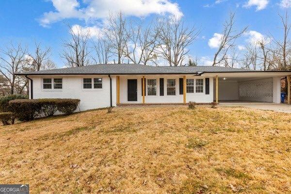 single story home with a front yard and a carport