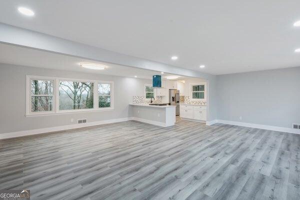 unfurnished living room with light hardwood / wood-style floors