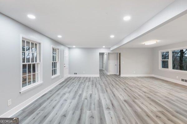 unfurnished living room featuring light wood-type flooring