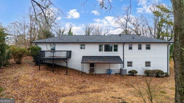 back of house featuring central AC and a deck