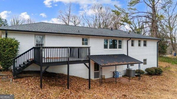 back of house featuring central AC and a deck