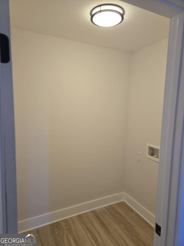 laundry room featuring hookup for a washing machine and hardwood / wood-style floors