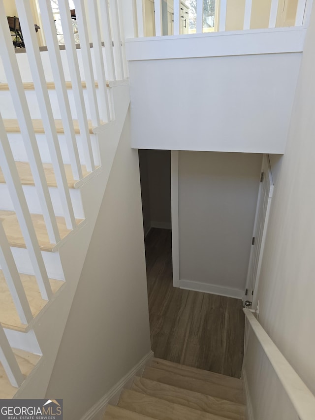 stairs featuring hardwood / wood-style floors