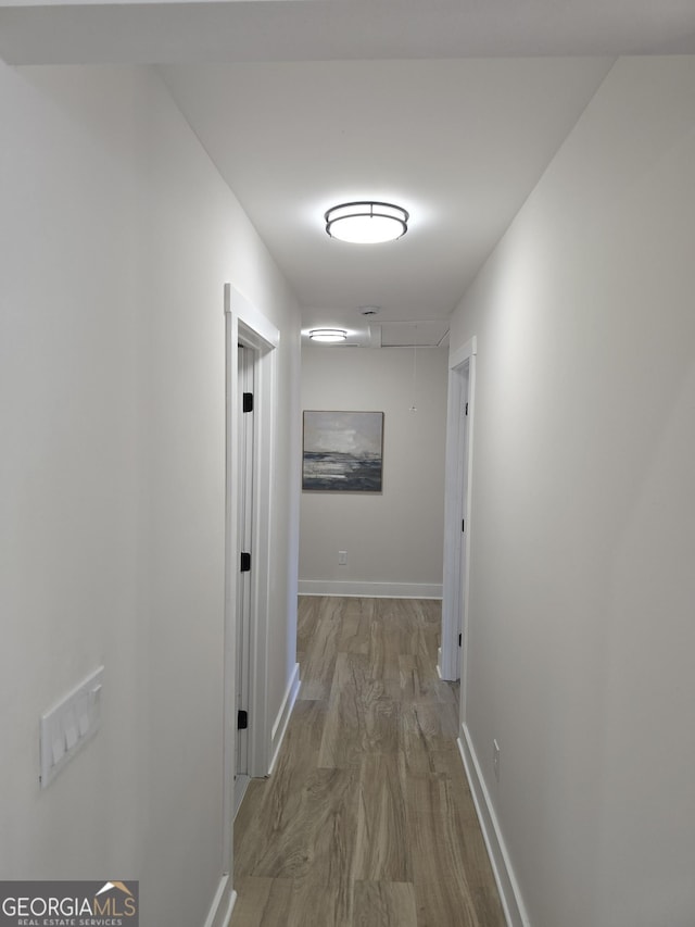 corridor with light hardwood / wood-style flooring