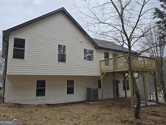 back of property featuring central AC unit and a deck