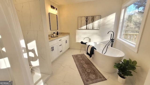 bathroom with vanity and a tub