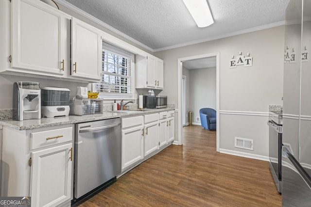 kitchen with white cabinetry, light stone countertops, stainless steel appliances, and a textured ceiling