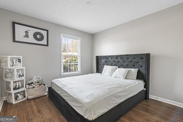 bedroom with dark wood-type flooring and a textured ceiling