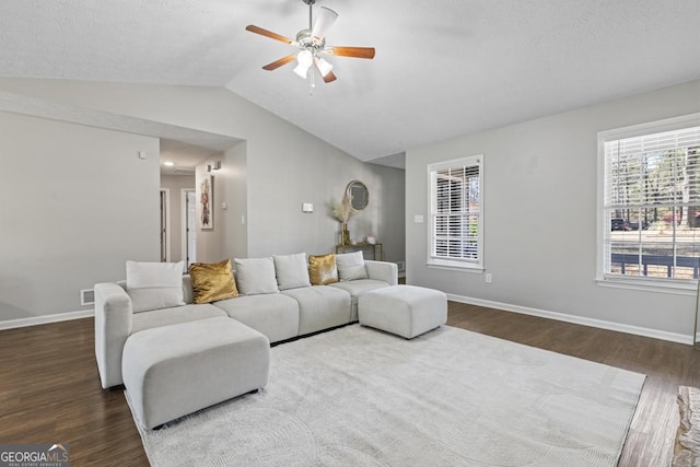 living room with lofted ceiling, hardwood / wood-style floors, and ceiling fan