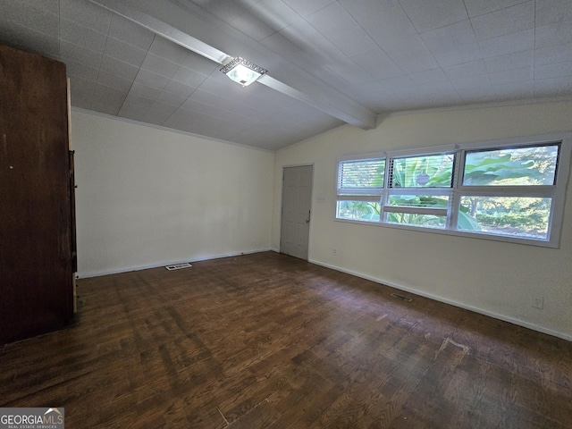 empty room with dark hardwood / wood-style floors and vaulted ceiling with beams