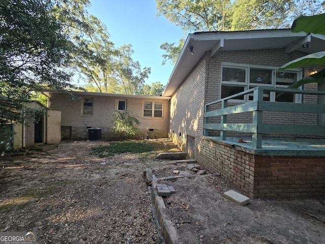 rear view of property with central AC unit