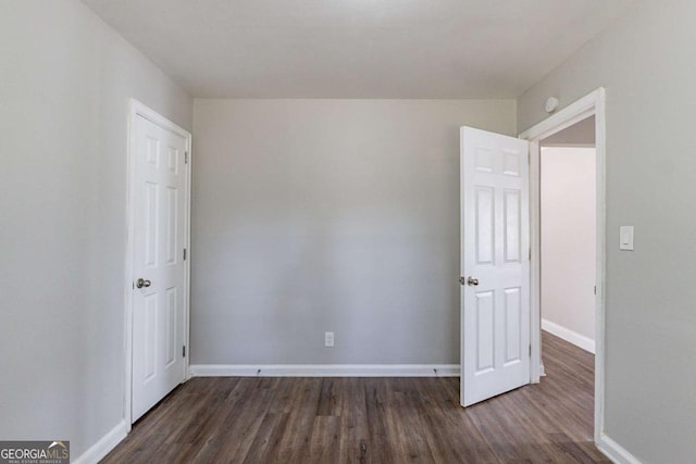 empty room featuring dark hardwood / wood-style flooring