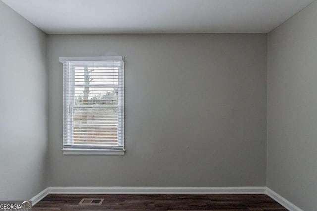 spare room featuring dark hardwood / wood-style flooring