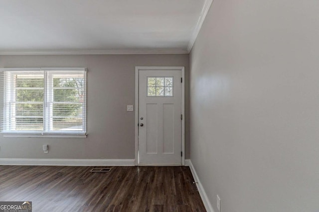 entrance foyer featuring ornamental molding and dark hardwood / wood-style floors