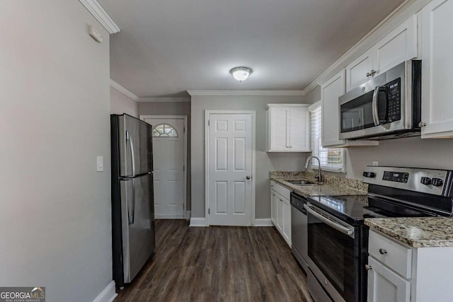 kitchen with white cabinetry, sink, light stone countertops, and appliances with stainless steel finishes