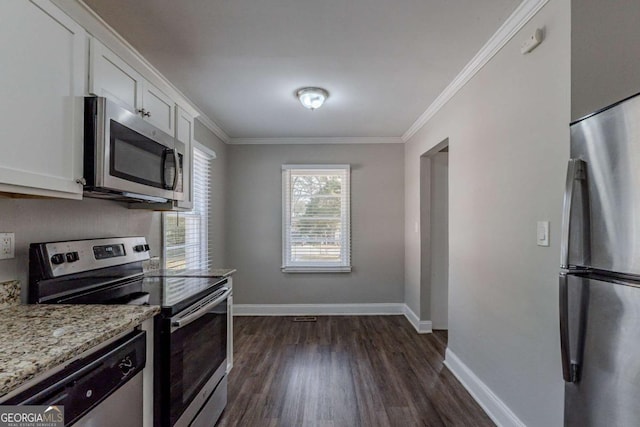 kitchen with white cabinetry, stainless steel appliances, light stone countertops, ornamental molding, and dark hardwood / wood-style flooring