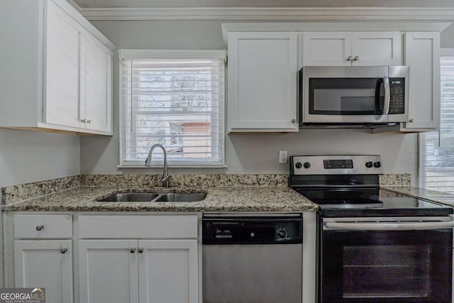 kitchen with white cabinetry, stainless steel appliances, and sink