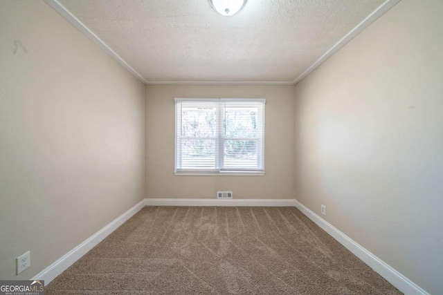 carpeted spare room featuring crown molding and a textured ceiling