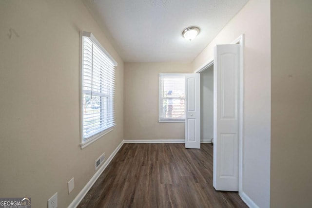 corridor featuring dark hardwood / wood-style flooring