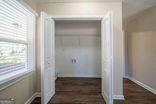 laundry room featuring washer hookup, dark wood-type flooring, and a textured ceiling