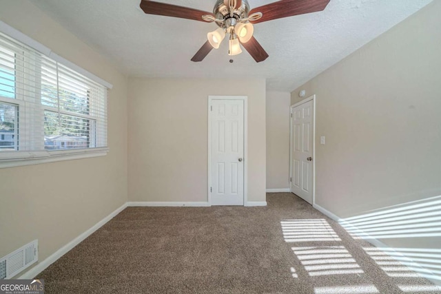 unfurnished bedroom with ceiling fan and carpet flooring