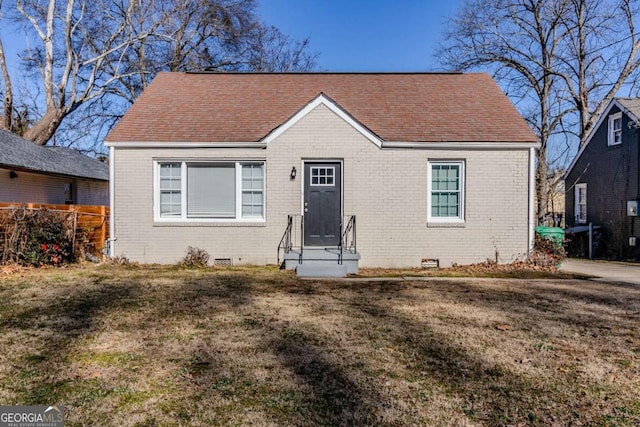 bungalow-style home featuring a front yard