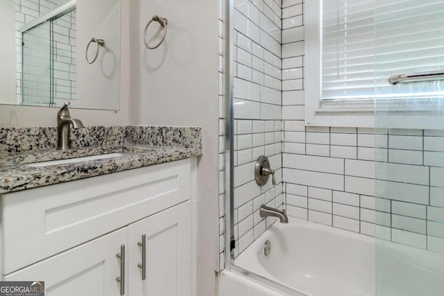 bathroom with vanity and combined bath / shower with glass door