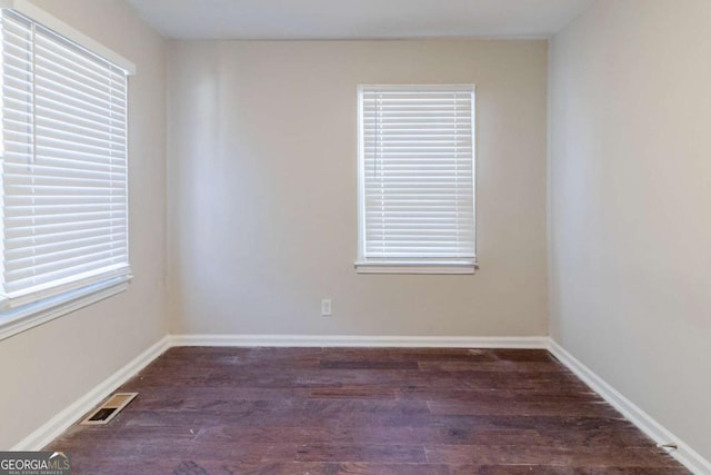 spare room with dark wood-type flooring