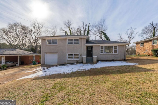 tri-level home featuring a carport, a garage, and a front lawn