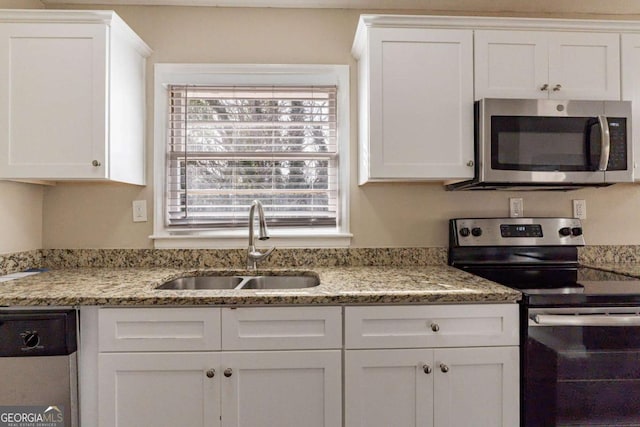 kitchen featuring a healthy amount of sunlight, sink, white cabinets, and appliances with stainless steel finishes