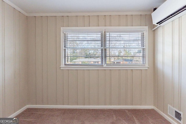 spare room with ornamental molding, a healthy amount of sunlight, and carpet