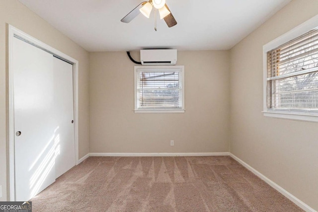 unfurnished bedroom featuring light carpet, a wall mounted air conditioner, a closet, and ceiling fan