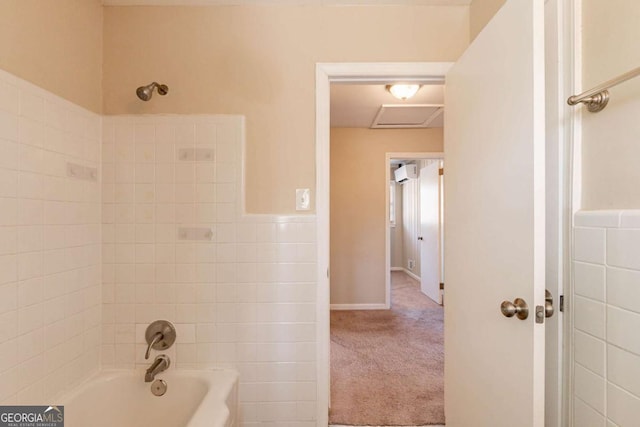 bathroom featuring a wall mounted air conditioner and tub / shower combination