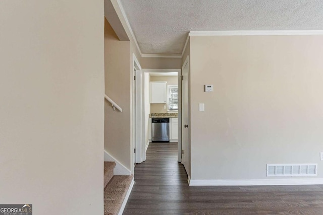 hallway featuring crown molding, dark wood-type flooring, and a textured ceiling